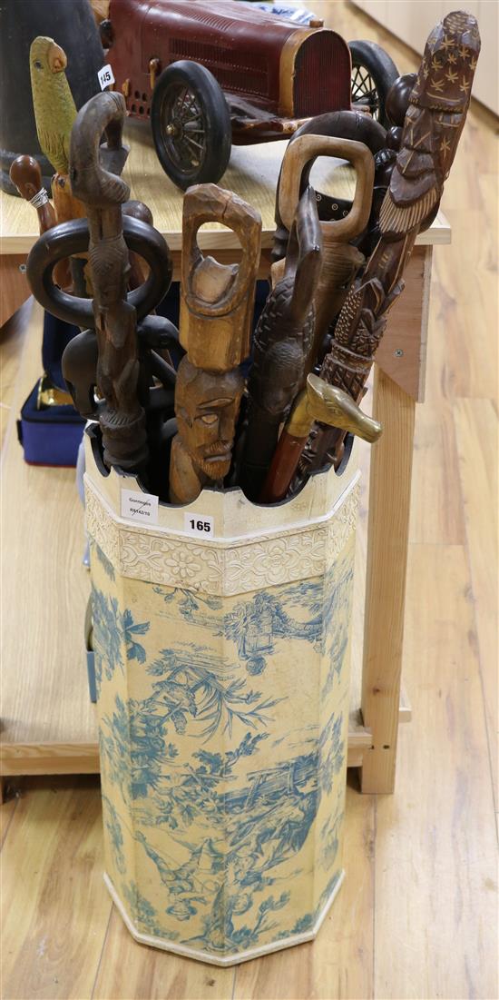 A collection of African hardwood walking sticks and stand